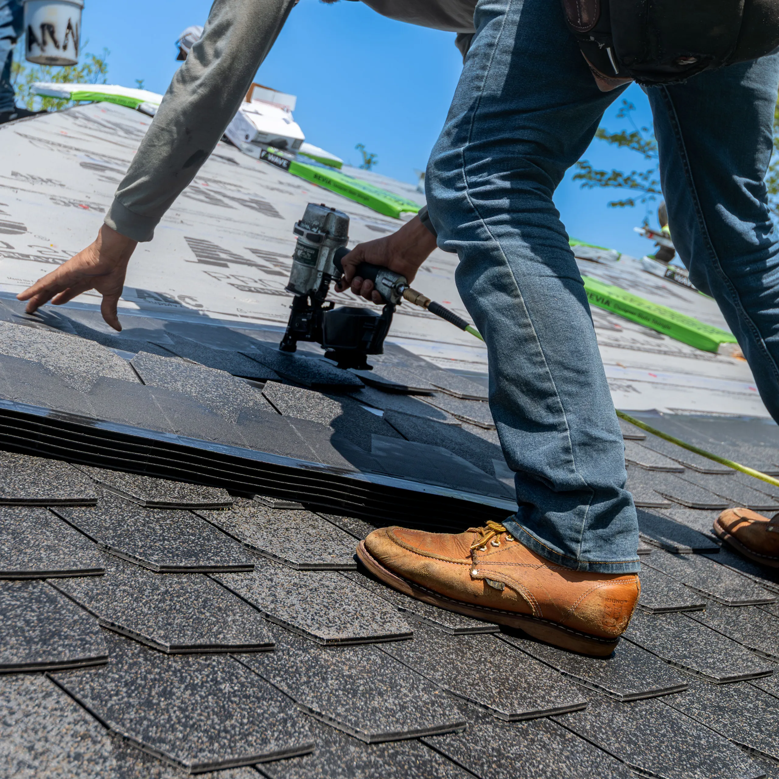 Roofer nailing shingles