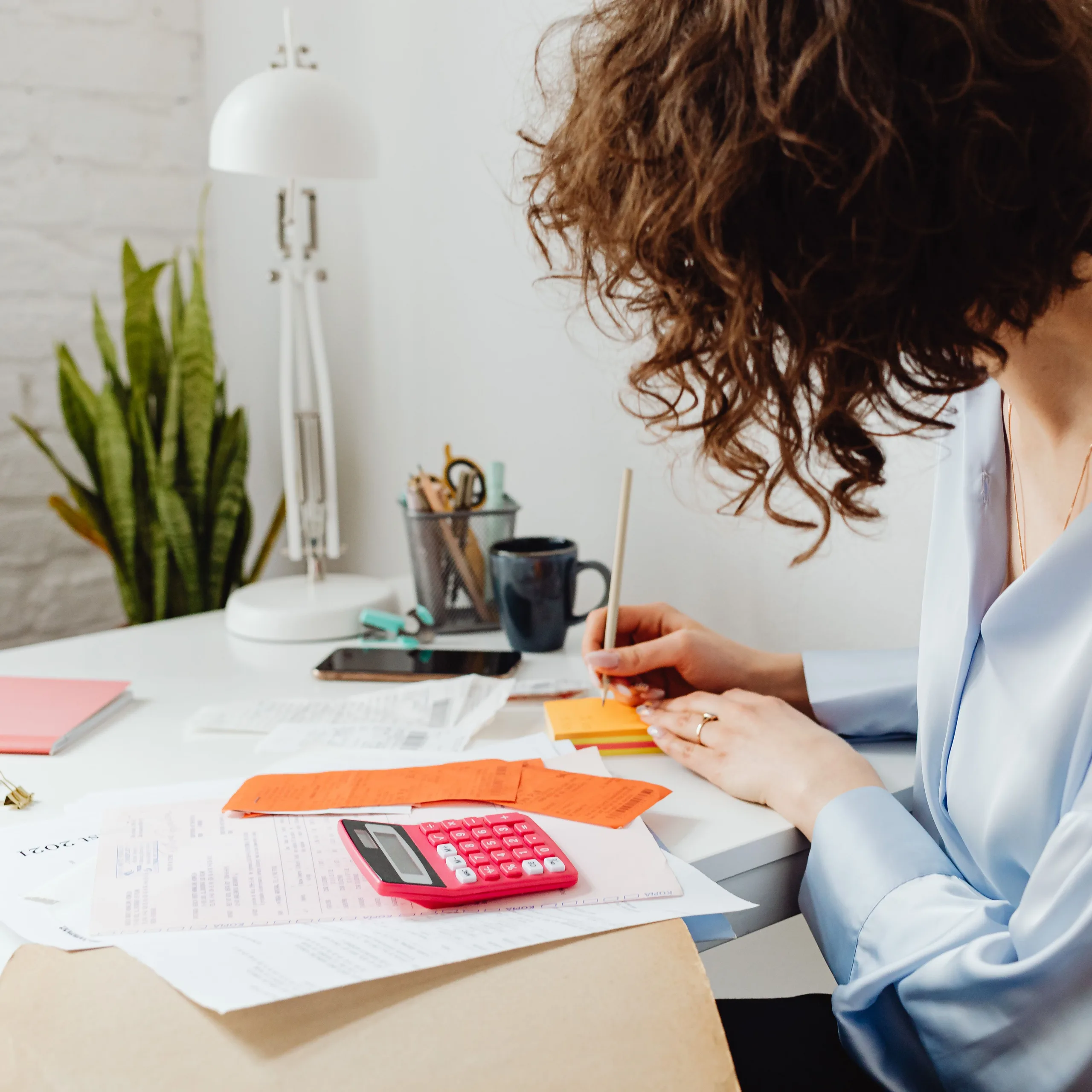 Accountant writing on a sticky note